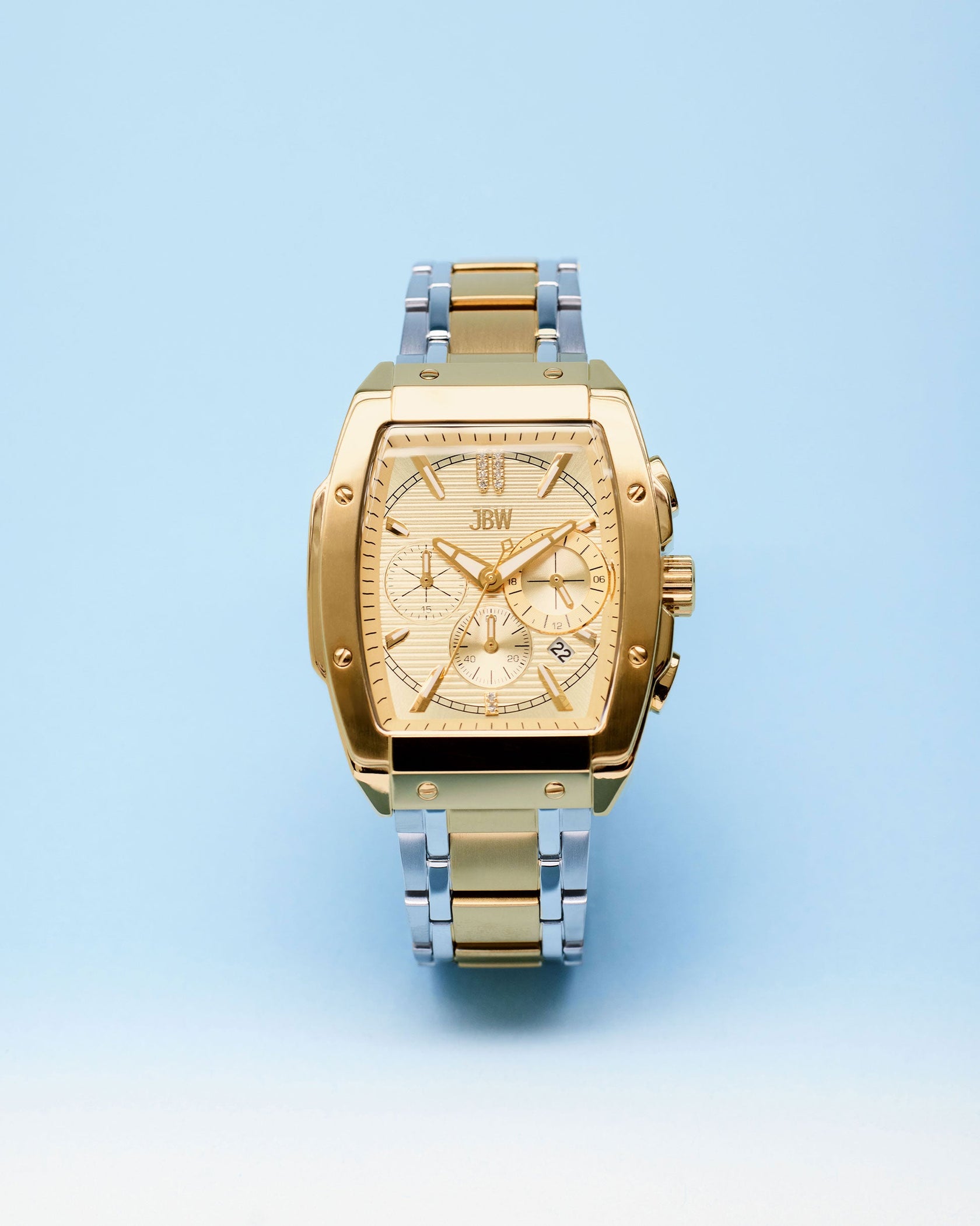 The JBW Watches Echelon | J6409B features a two-tone gold design, a square face with three subdials, and a stainless steel band, displayed against a light blue background.