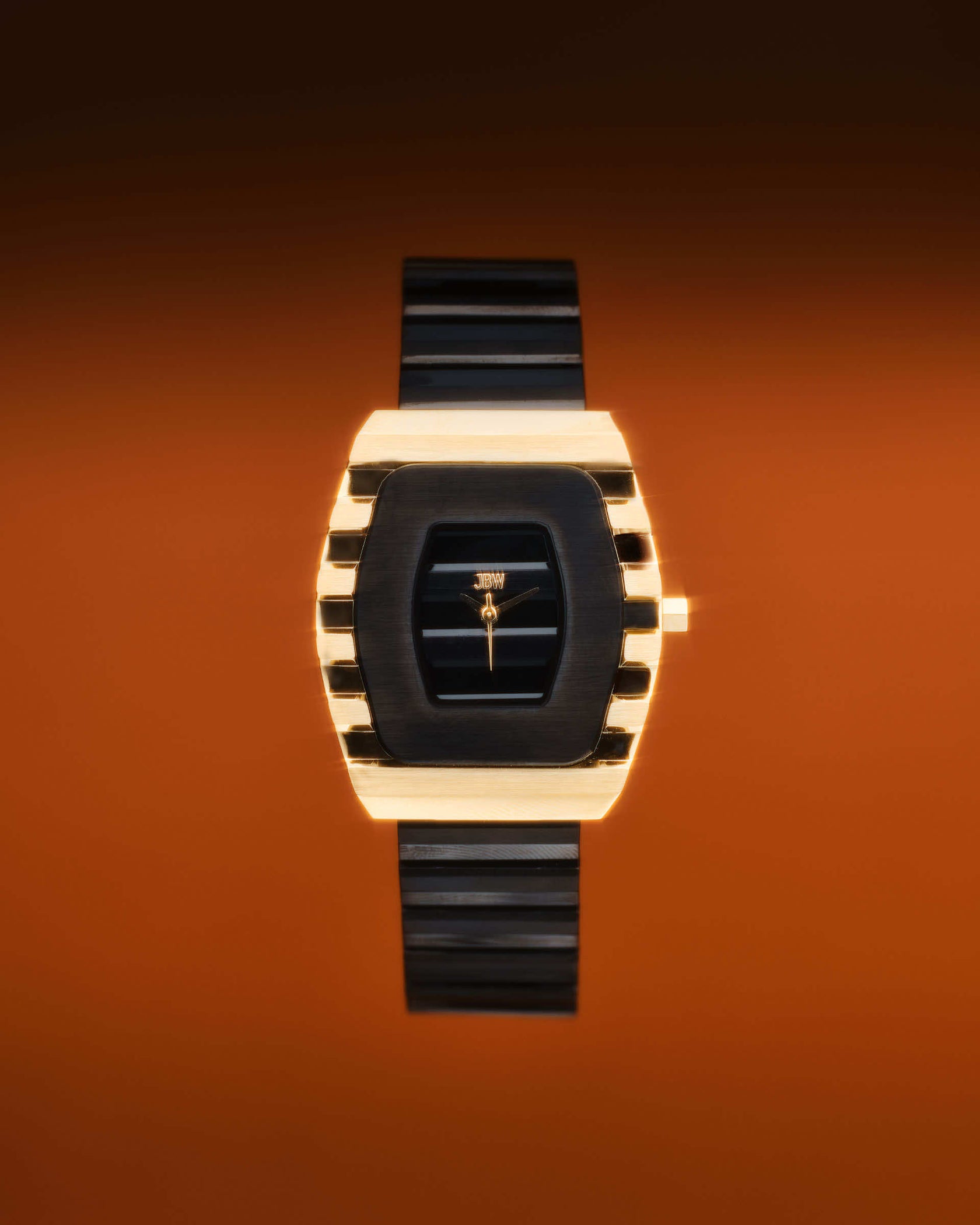 The JBW Watches Atlas | J6403F features a stylish 34mm gold and black rectangular case, black strap, and minimalistic dial on a gradient orange background, powered by precise Swiss Ronda movement for reliable timekeeping.