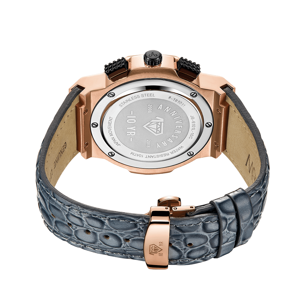 The JBW Saxon 10 YR (JB-6101L-10C) is a luxury diamond watch featuring a rose gold case, engraved anniversary case back, and textured blue-gray genuine leather strap with clasp.