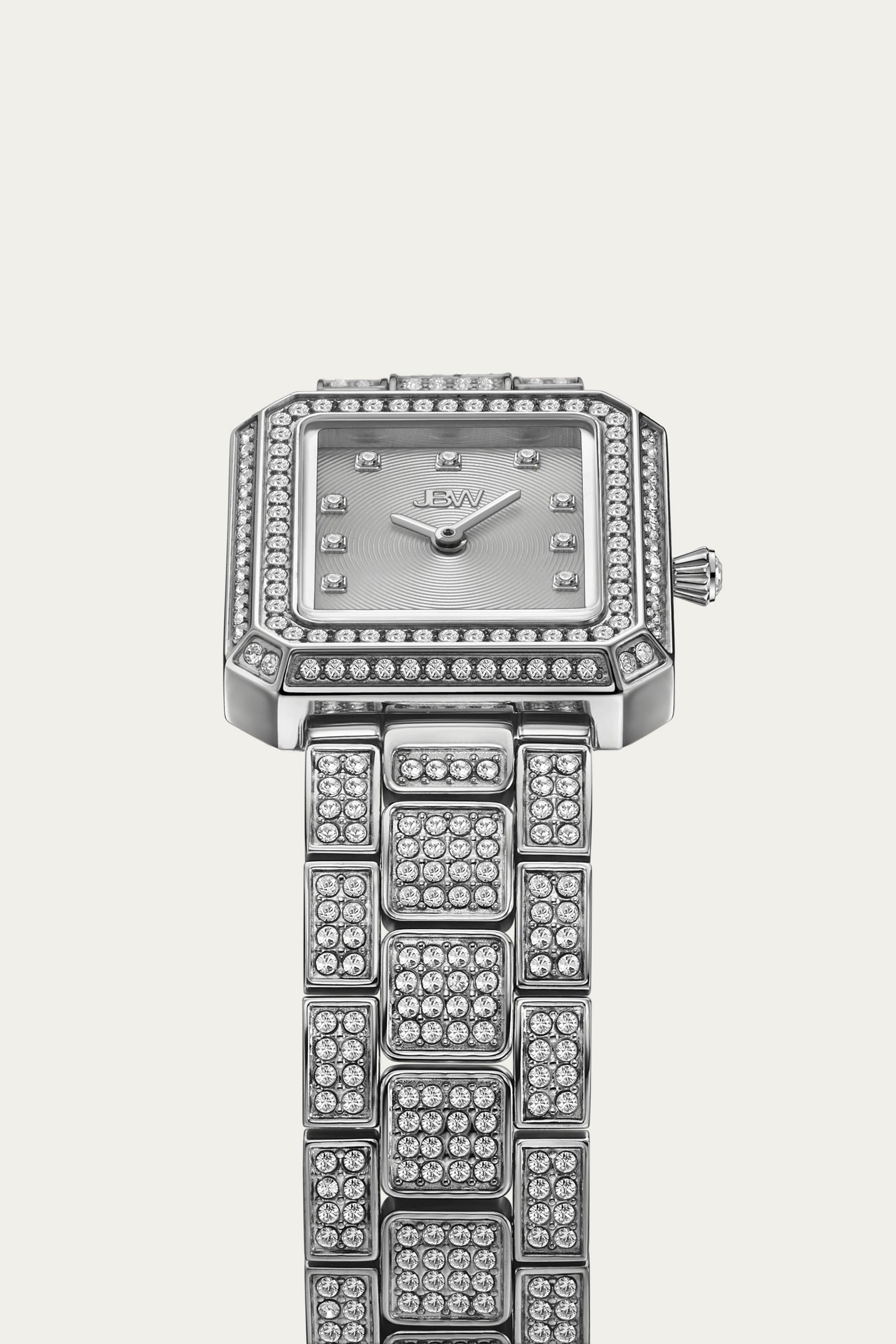 The JBW Watches Arc Single | J6390B-GA Sample Sale (Grade A) is a square-faced women’s luxury watch with a diamond-encrusted bezel and bracelet, crystal accents, textured dial, silver hour markers, JBW logo, and sparkling stones for brilliance.