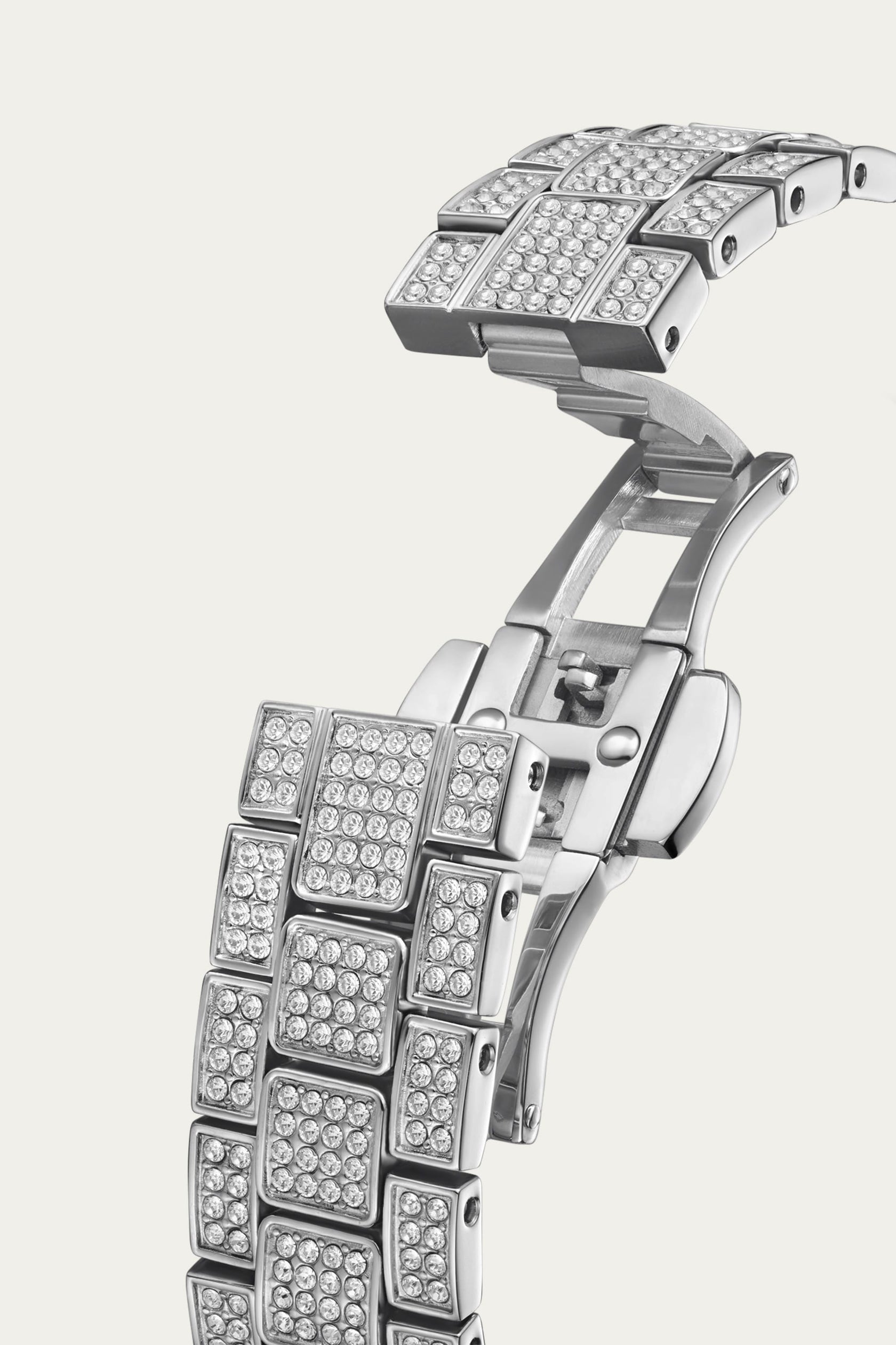 A close-up of the Arc Single | J6390B-GA Sample Sale (Grade A) by JBW Watches—a womens silver metal luxury band with a butterfly clasp, featuring square segments adorned with sparkling crystals.