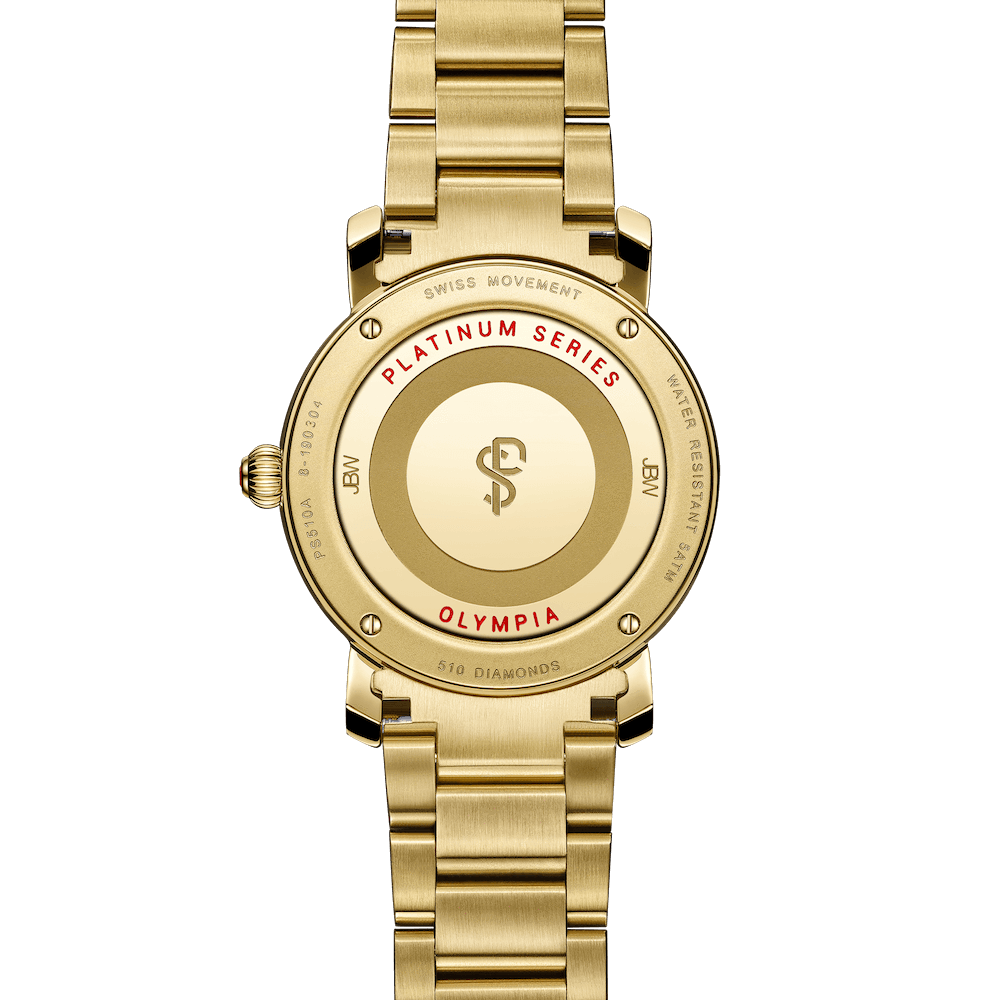 A close-up of the back of the JBW Olympia PS | PS510A, an 18K gold-plated diamond watch engraved with PLATINUM SERIES, OLYMPIA in red, SWISS MOVEMENT, WATER RESISTANT, and 510 DIAMONDS around the case.