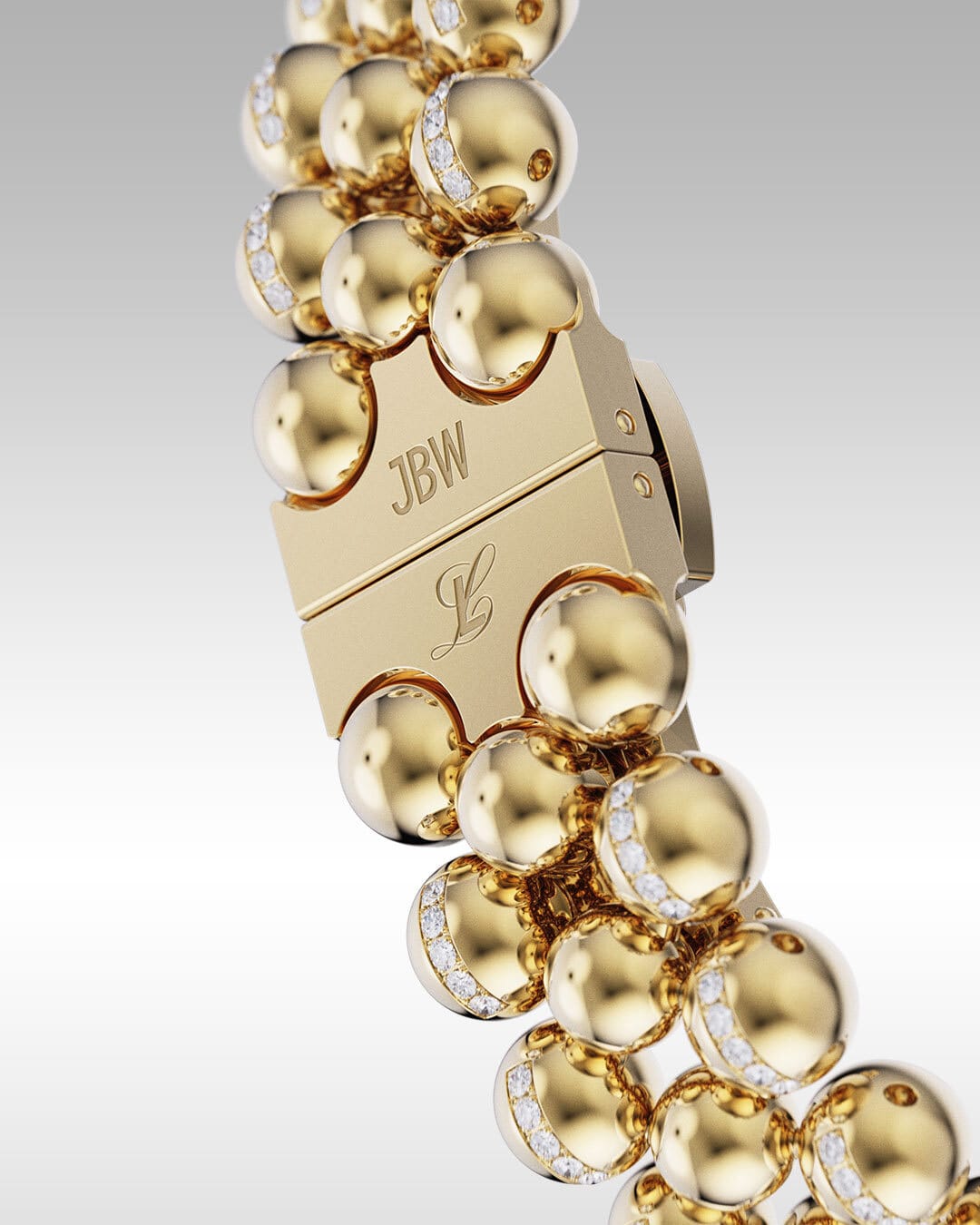 A close-up of the JBW x Luar – Atmosphere (Sample Sale) J6406A-SC bracelet by JBW Watches, showcasing 18k gold-plated spherical links with diamonds and a clasp engraved with JBW and a cursive L on a gradient gray background.