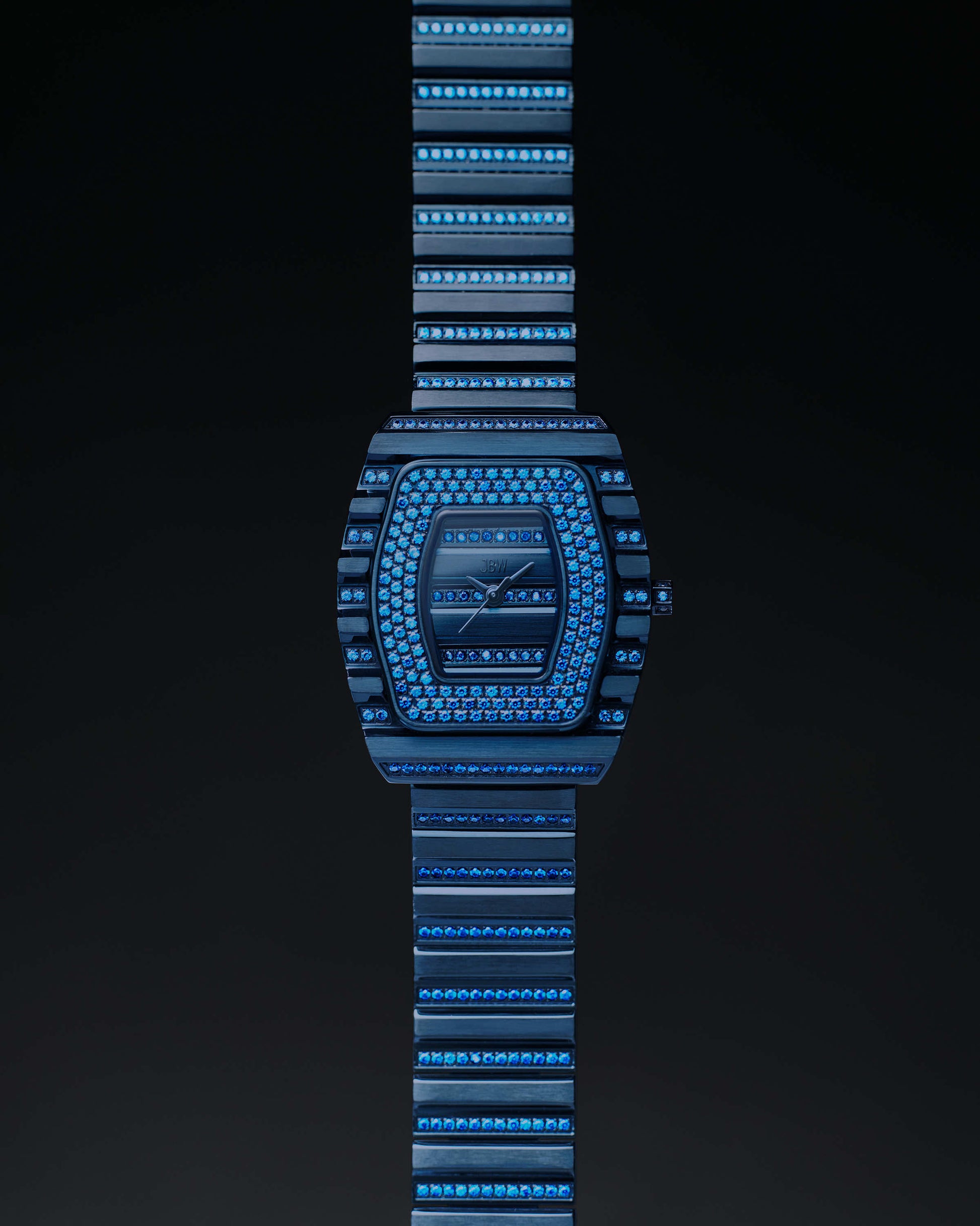 The RESERVE Atlas Bleu | R6404A by JBW Watches is a limited edition luxury blue crystal watch with gemstones, a geometric face, matching blue metal strap, Swiss quartz movement, shown on a dark background.