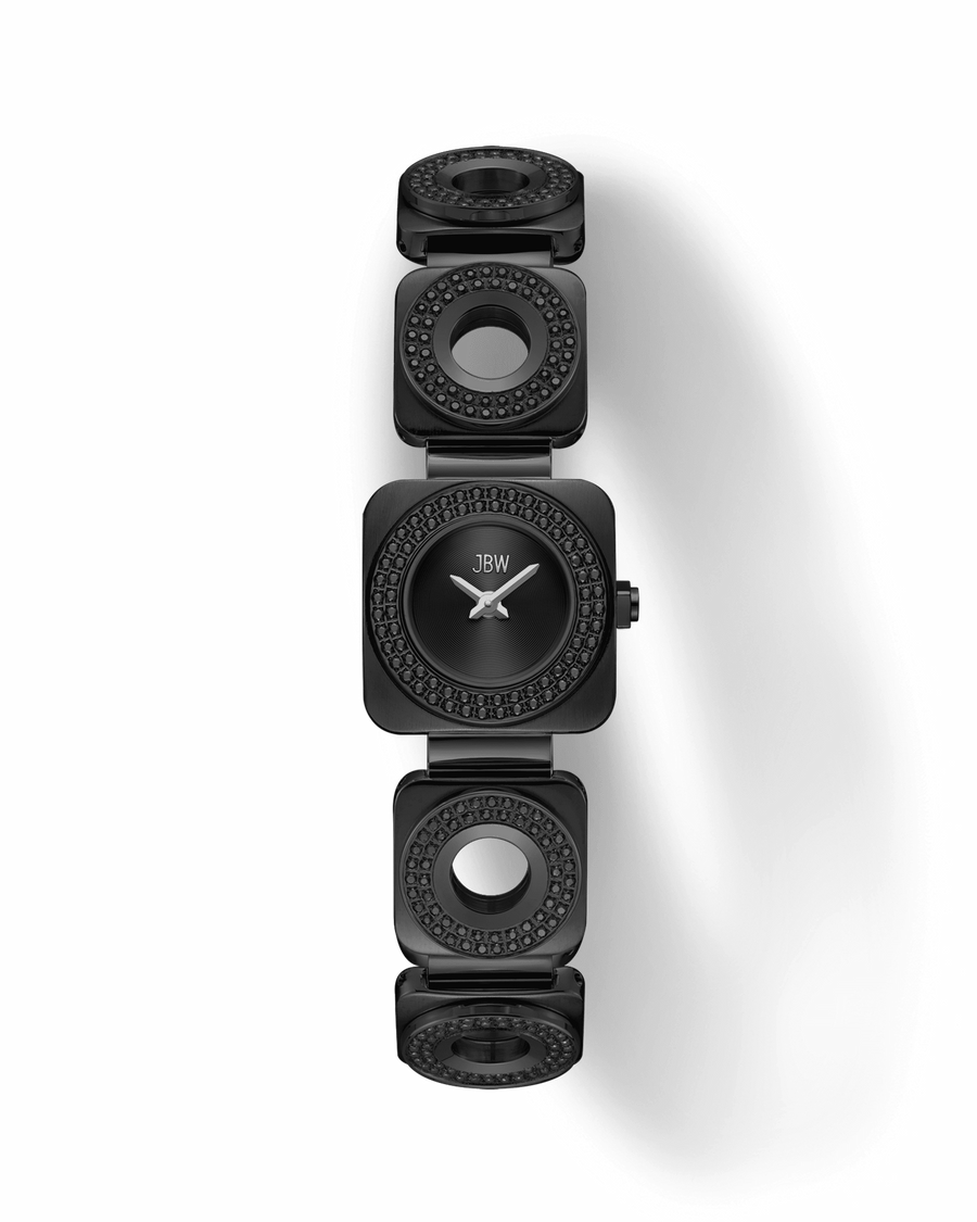 The JBW Watches Chasm | J6399C is a sleek black timepiece with a square face, minimalist dial, and a unique band of circular links featuring black gemstones, all set against a striking black background.