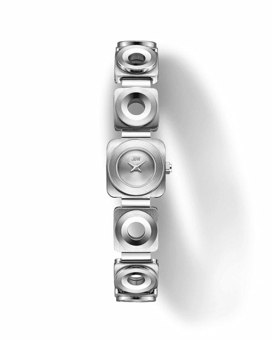 The JBW Watches Chasm Petite (Sample Sale) | J6400B-SC features a modern silver square face and geometric stainless steel bracelet links with circular cutouts, shown on a light background. Powered by precise Japanese VX movement.