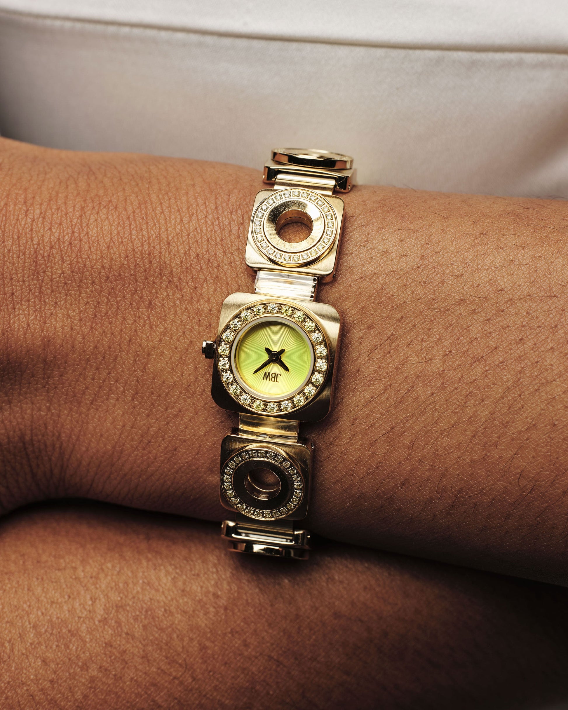 The JBW Watches Chasm Petite (Sample Sale) | J6401D-SC features an 18k gold-plated finish, a round green face with premium crystals, decorative circular links, and Japanese VX movement—shown worn on the wrist against a neutral background.