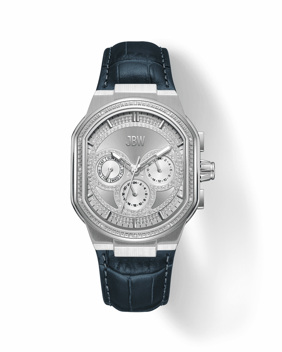 The JBW Orion | J6408A is a luxury silver wristwatch with a geometric face, multiple sub-dials, crystal accents, a dark blue textured leather strap, and precise Japan-made movement set against a light background.