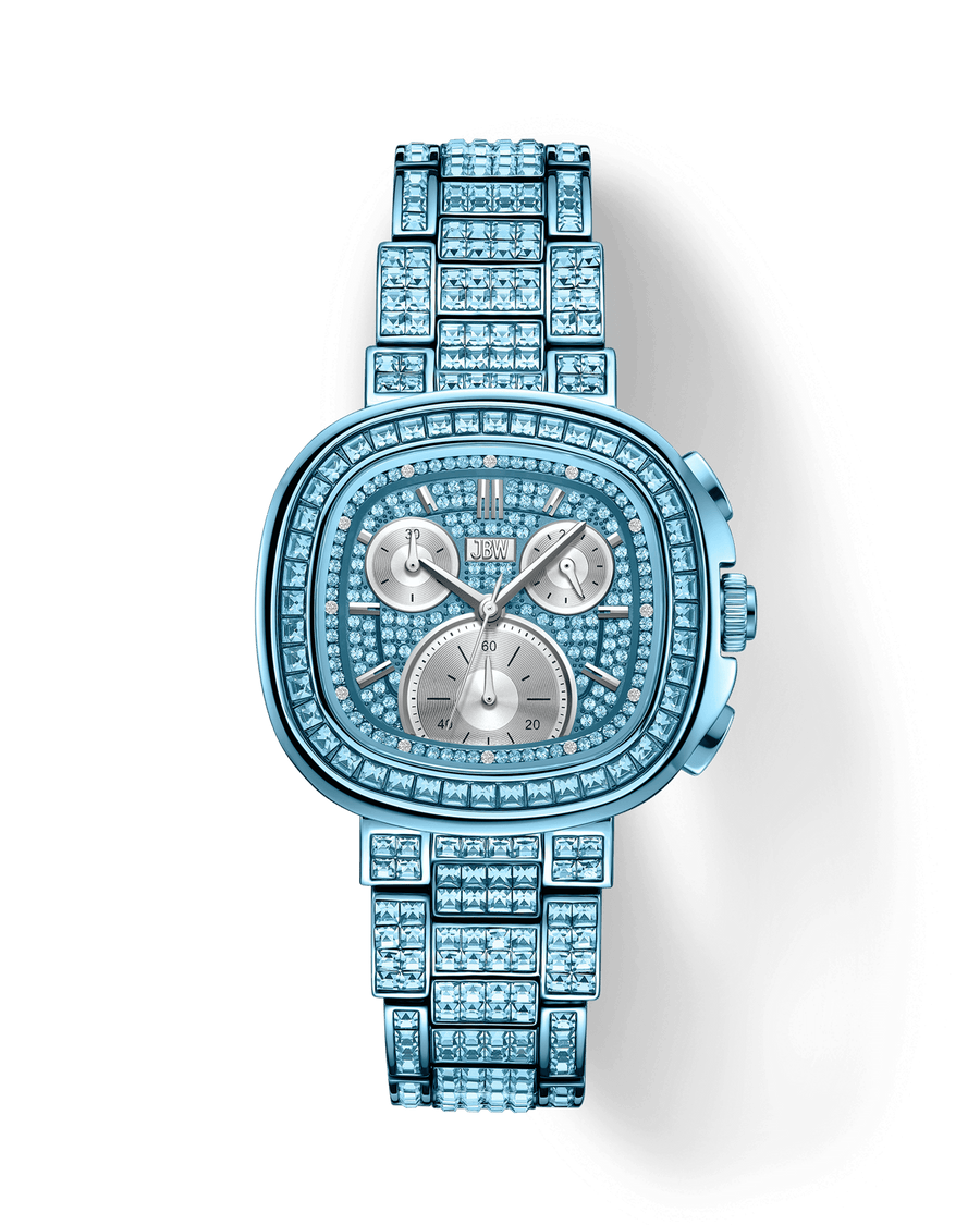 The JBW Watches RESERVE Coast Aqua | R6397C is a luxury wristwatch with a square face, blue stones on the band and dial, three subdials, silver markers, and a striking metallic finish for a sparkling look.