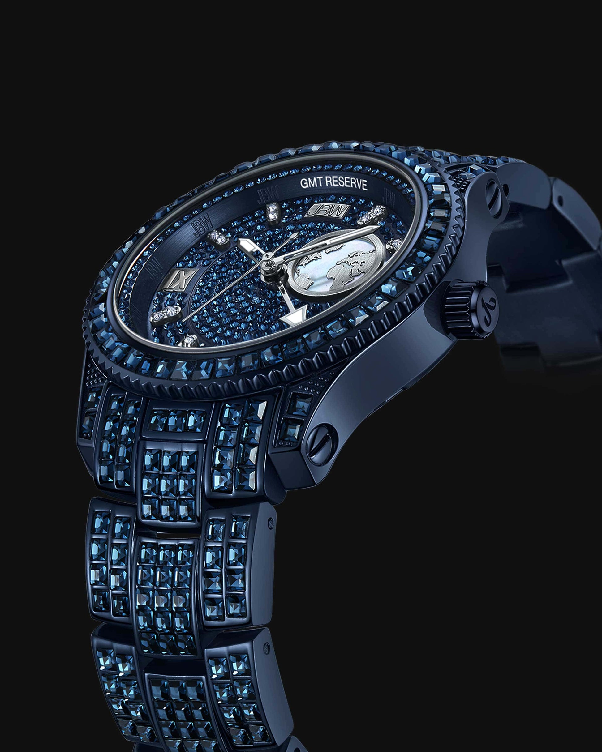 The RESERVE Bleu 39 | R6393A-GA by JBW Watches is a luxury GMT watch with a sapphire blue crystal-encrusted dial, metallic blue case and bracelet, Swiss GMT movement, and intricate details—all set against a striking black background.
