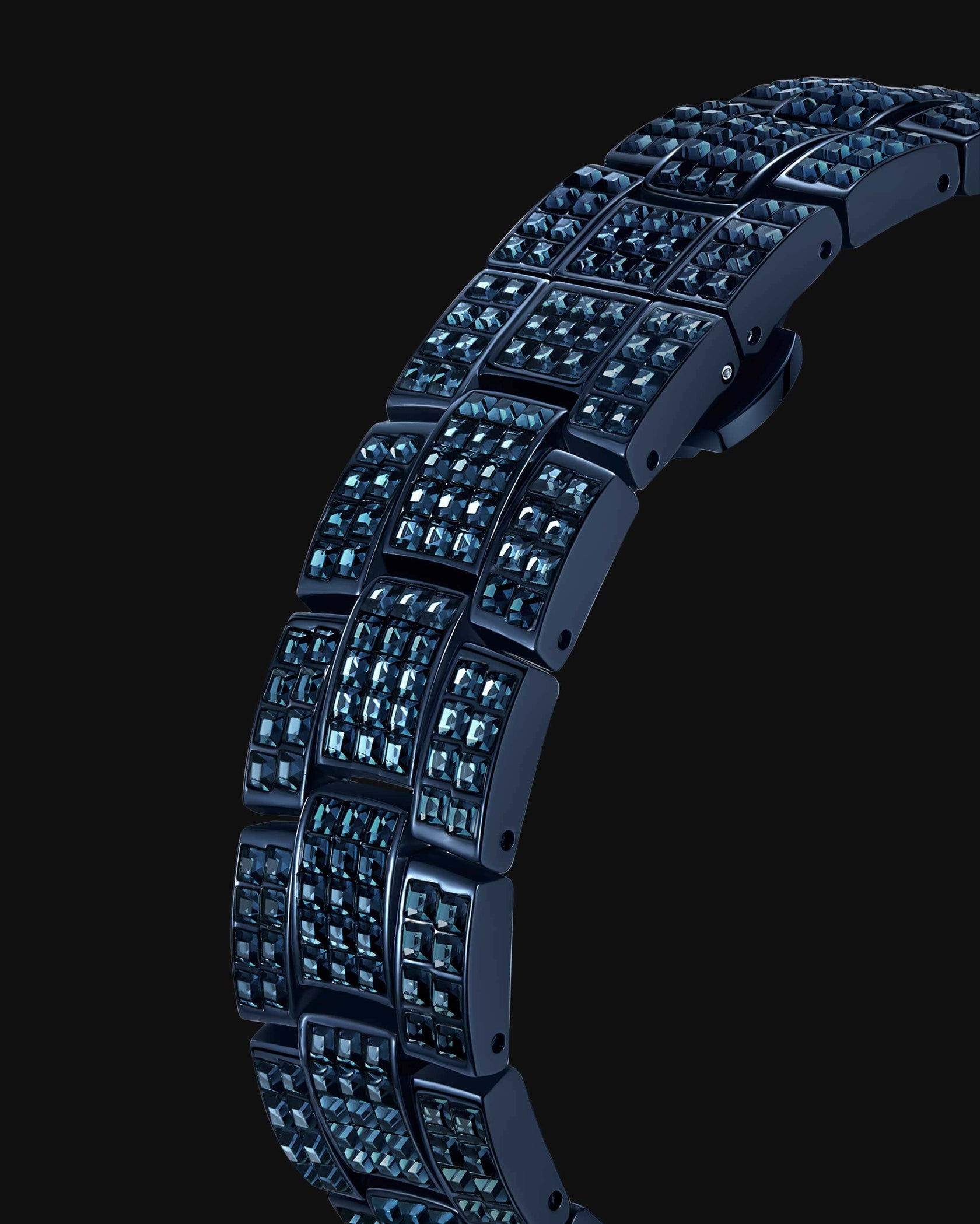 A close-up of the JBW Watches RESERVE Bleu 39 | R6393A-GA bracelet, showing rows of glossy dark blue square links inlaid with sparkling blue gemstones, set against a black backdrop.